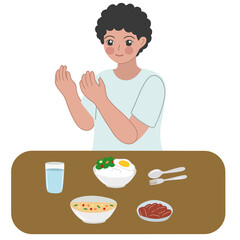 boy praying before a meal