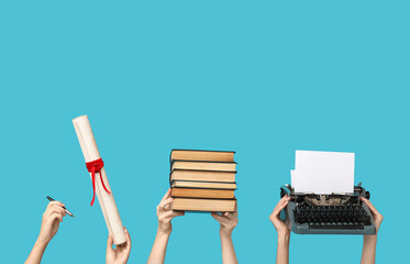 Women with vintage typewriter, diploma and books on blue background