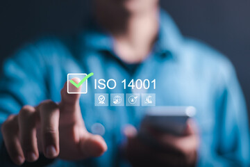 ISO 14001 concept. Businessman touching virtual screen of ISO 14001 certified for environmental...