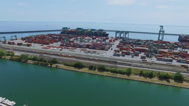 Transport moves among containers in Voltri Terminal Europa port at summer