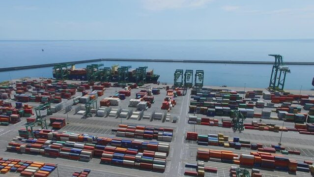 Barge is loaded in Voltri Terminal Europa port at summer day. Aerial view