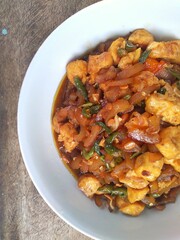 Kikil or cow skin with spicy flavors is minang cuisine of West Sumatra, Indonesia. Kikil Cooked using Indonesian herbs, such as red chilies, shallots, garlic, tomatoes, etc.