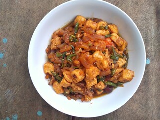 Kikil or cow skin with spicy flavors is minang cuisine of West Sumatra, Indonesia. Kikil Cooked using Indonesian herbs, such as red chilies, shallots, garlic, tomatoes, etc.