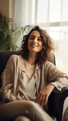 Fototapeta premium A Happy woman sitting in comfortable chair in home design, relaxing, breathing fresh air. A smiling young female tenant or a tenant relaxing in an armchair relieves negative emotions