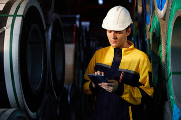 technician or worker working on tablet and checking Sheet metal products in the factory