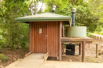An environmentally friendly public toilet structure with a sealed unit and water tank at Hastie's Swamp on the Atherton Tablelands in Queensland, Australia. - obrazy, fototapety, plakaty
