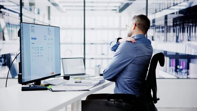 Side View Of Accountant Suffering From Back Pain At Desk