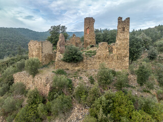 Fototapeta na wymiar Aerial view of Castell de Vilaroma near Palamos on the Costa Brava, hilltop castle ruin with towers above the valley of St Joan de Palamos