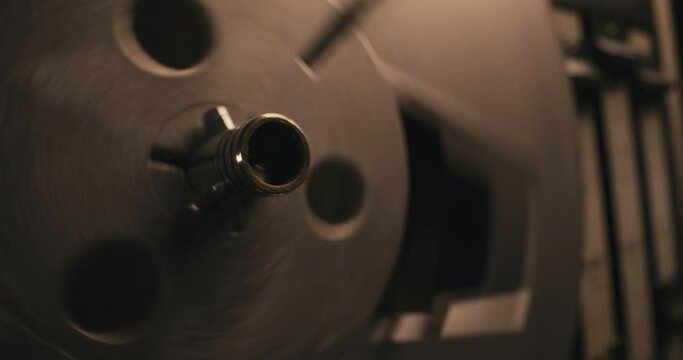 Close-up on a  vintage tape recorder spinning in a blinking light