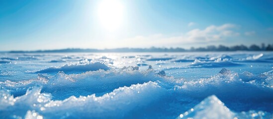 Snow-covered field with transparent blue ice floes on frosty sunny day. Perfect for text.