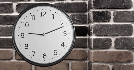 Image of clock ticking over brick wall background