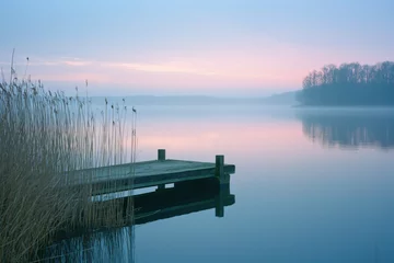 Fotobehang Tranquil Morning: Lakeside Reflections at Sunrise © Kunlapat