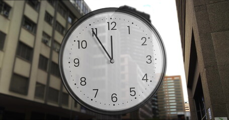 Image of clock ticking over cityscape