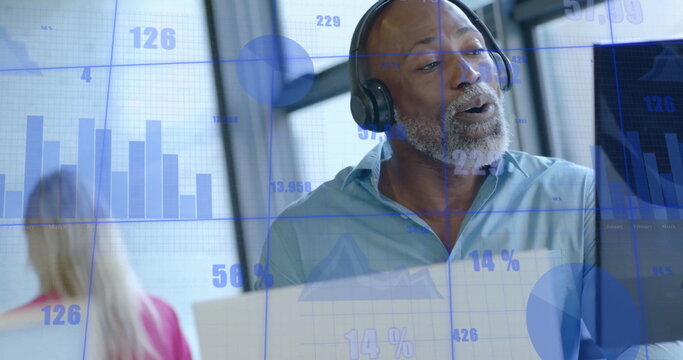 Image of interface processing data over happy african american having image call at office