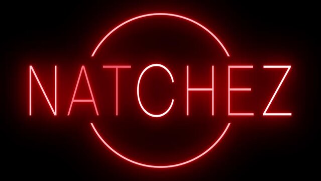 Flickering red retro style neon sign glowing against a black background for NATCHEZ