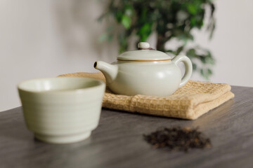 Fototapeta na wymiar Cup, teapot, and dry tea resting on a table