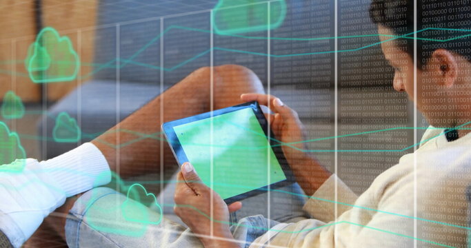 Image of clouds and data processing over biracial man using tablet
