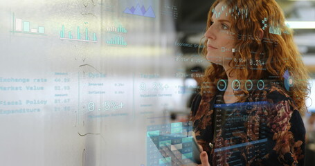 Image of financial data with icons over caucasian businesswoman in office