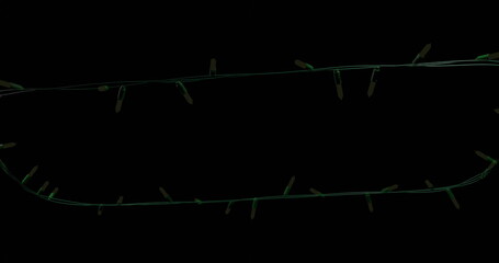 Yellow christmas string lights flashing on black background