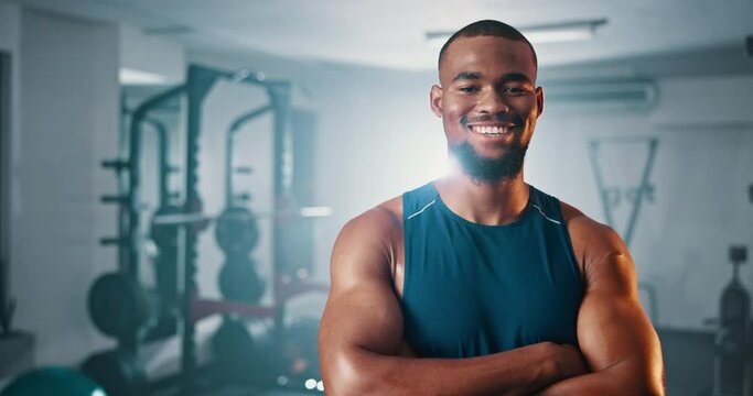Gym, arms crossed and happy black man confident in fitness club, muscle building or strength exercise. Smile, portrait and African bodybuilder with pride in athlete workout, training and challenge