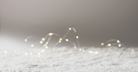 A soft focus captures twinkling fairy lights on a surface