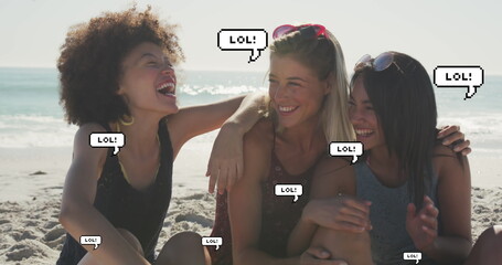Image of speech bubbles with lol text over female friends smiling on beach - Powered by Adobe