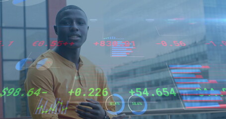 Image of financial data processing over african american businessman in office