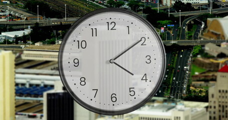 Image of clock ticking over cityscape