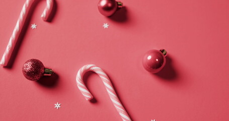 Candy canes and baubles decorate a festive background