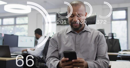 Image of data processing over african american businessman using smartphone in office