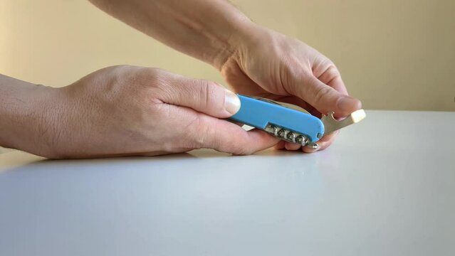Man opening folding pocket knife, close up