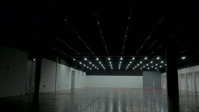 Cinematic gimble shot of empty hall with lights turning on.