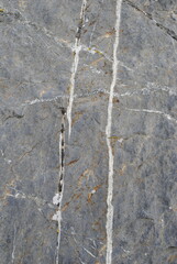 White quartz mineral vein in dark igneous rock close up macro