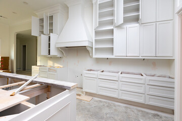 House under construction with new cabinets in kitchen
