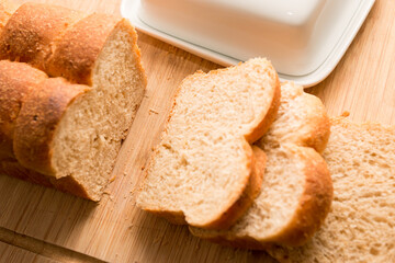 Sliced white Bread on the bamboo desk with butter, homemade bakery concept