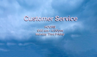Stenciled letters on glass stating Customer Service against a blue sky