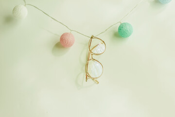Pastel pink glasses on white background