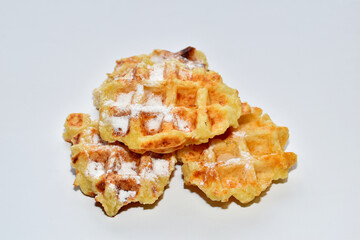 Belgian waffles covered in powdered sugar.