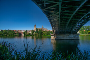 Fototapeta na wymiar Bridge of Sanchez Fabres in Salamanca over Tormes river and Cathedral, Spain