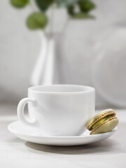 Coffee cup and one macaroon on the table with copy space at the top of the frame