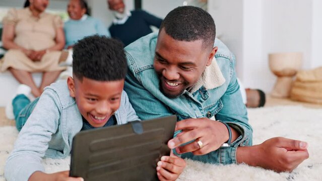 Dad, boy and tablet on floor, family or laugh together at meme, comic video or movie in living room. Father, child or digital touchscreen on carpet for streaming subscription in lounge, house or joke
