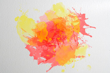 Watercolor brush stroke in yellow, pink and orange on textured paper. Background.