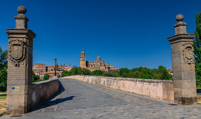Panoramic view to cityscape from the roman pedestrian bridge Puente Romano. Old town with ancient...