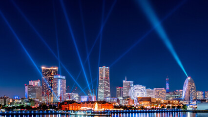 City view of Yokohama Minato-Mirai with laser show at night
