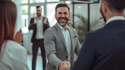 Businessmen smiling and shaking hands in office People applauding behind photography of happy businessmen ,  