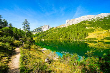Fototapeta na wymiar Steirersee on the high plateau of the Tauplitzalm. View of the lake at the Toten Gebirge in Styria. Idyllic landscape with mountains and a lake on the Tauplitz in Austria. 