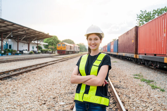 Portrait of woman engineer railway standing and looking camera in train factory. Maintenance cycle concept.