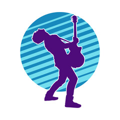 Silhouette of a musician playing electric guitar musical instrument. Silhouette of a male guitar player performing.