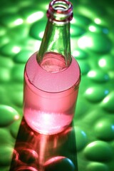 bottle with pink liquid on green surface. mockup