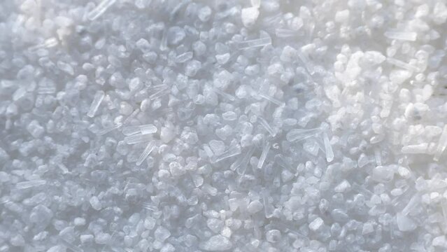 White Monosodium Glutamate (MSG) crystals circle rotation close up top view